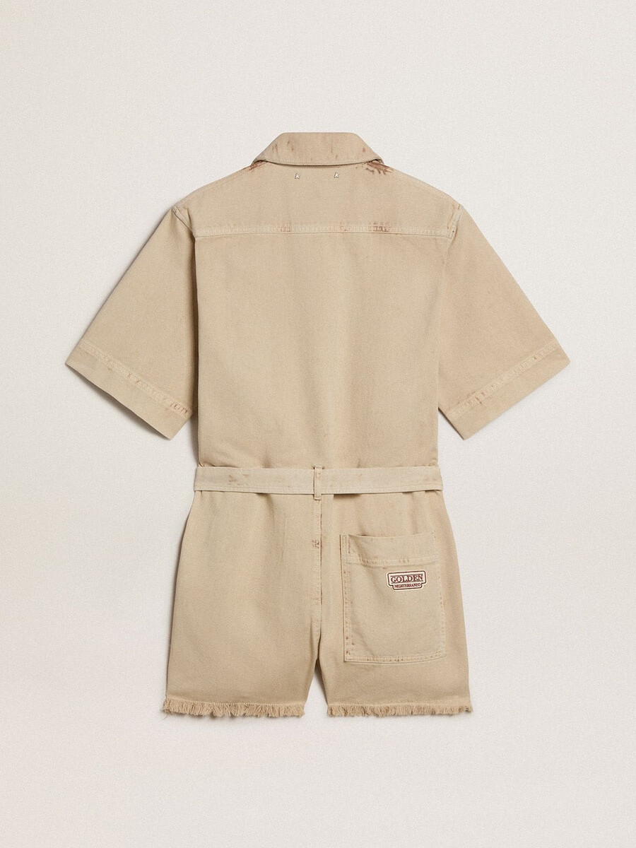 damen-jumpsuit aus beigefarbenem denim mit gürtel und ausgefranstem saum
