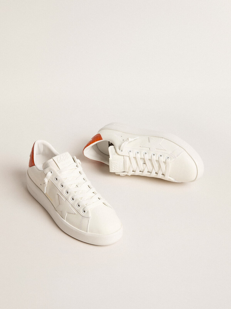 purestar damenschuh mit weißem lederstern und orangefarbener fersenlasche
