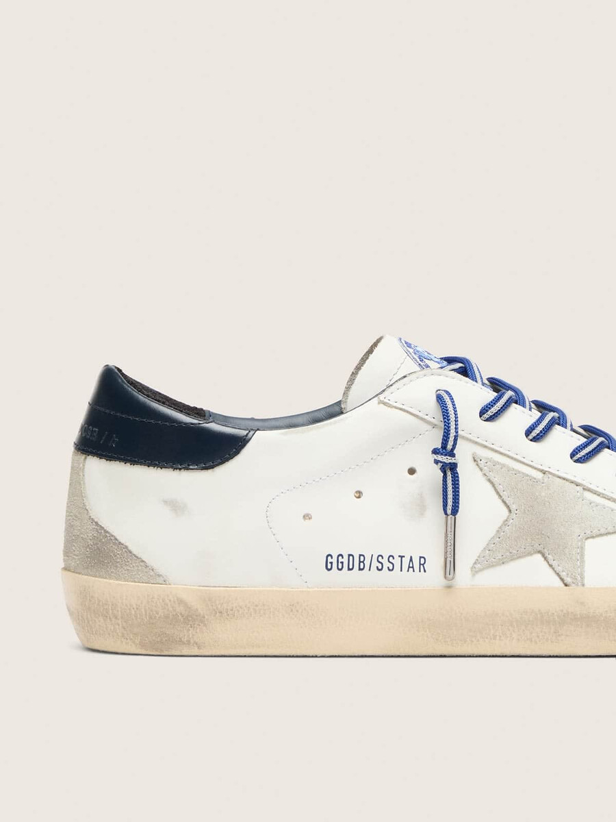 der vom tennis inspirierte damen-sneaker super-star ltd aus weißem leder mit wildlederstern und blauer leder-fersenlasche