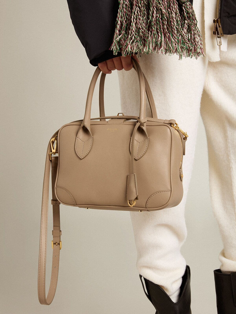 vita-tasche aus taupefarbenem leder mit goldenen details